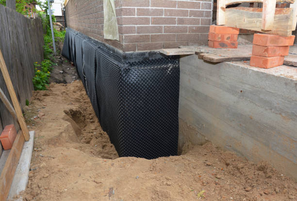 SJ Waterproofing Pros technician performing targeted Wet Basement Repair assessment in Palmyra, NY